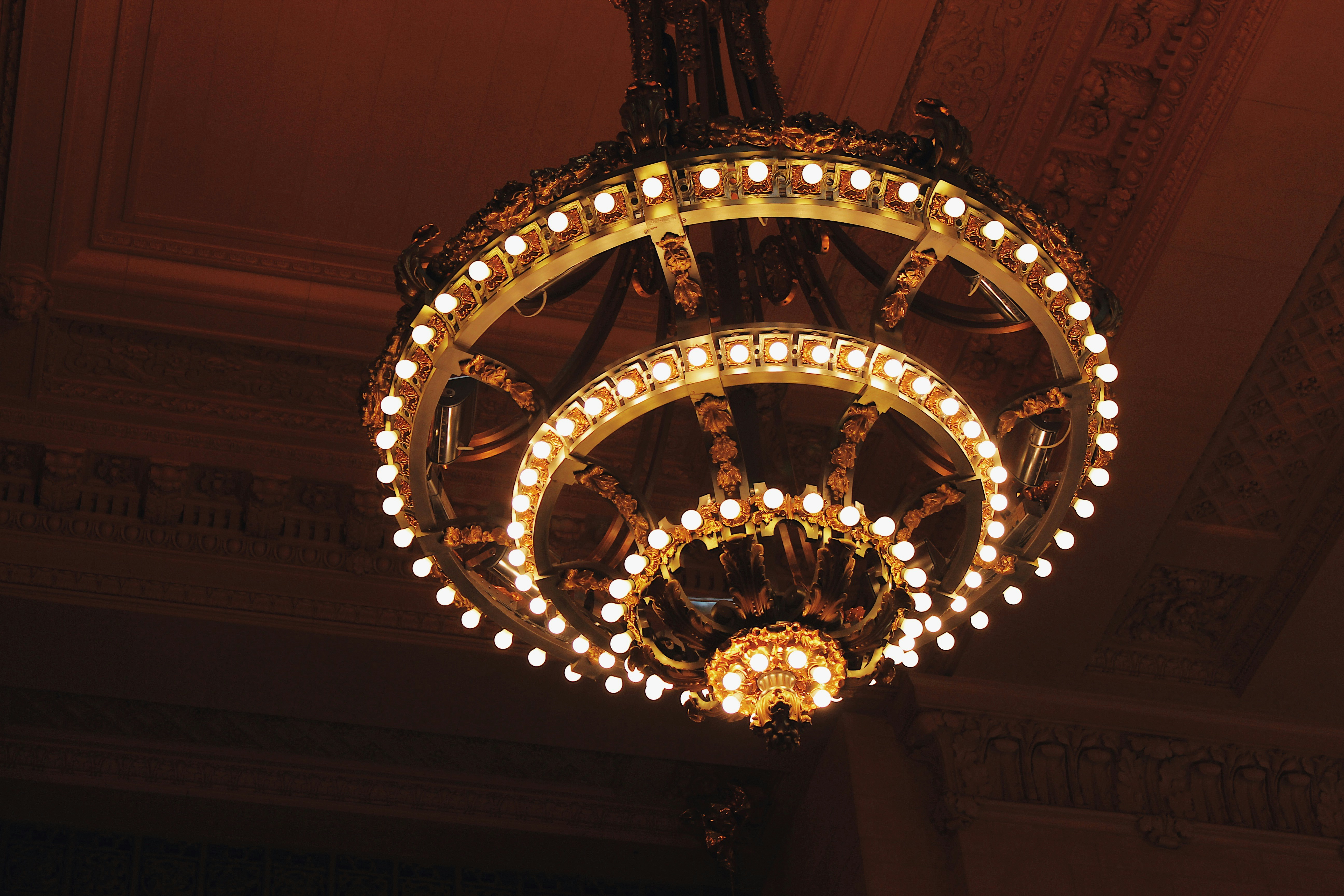 Ornate multi-tiered gold chandelier installation in Dubai ballroom