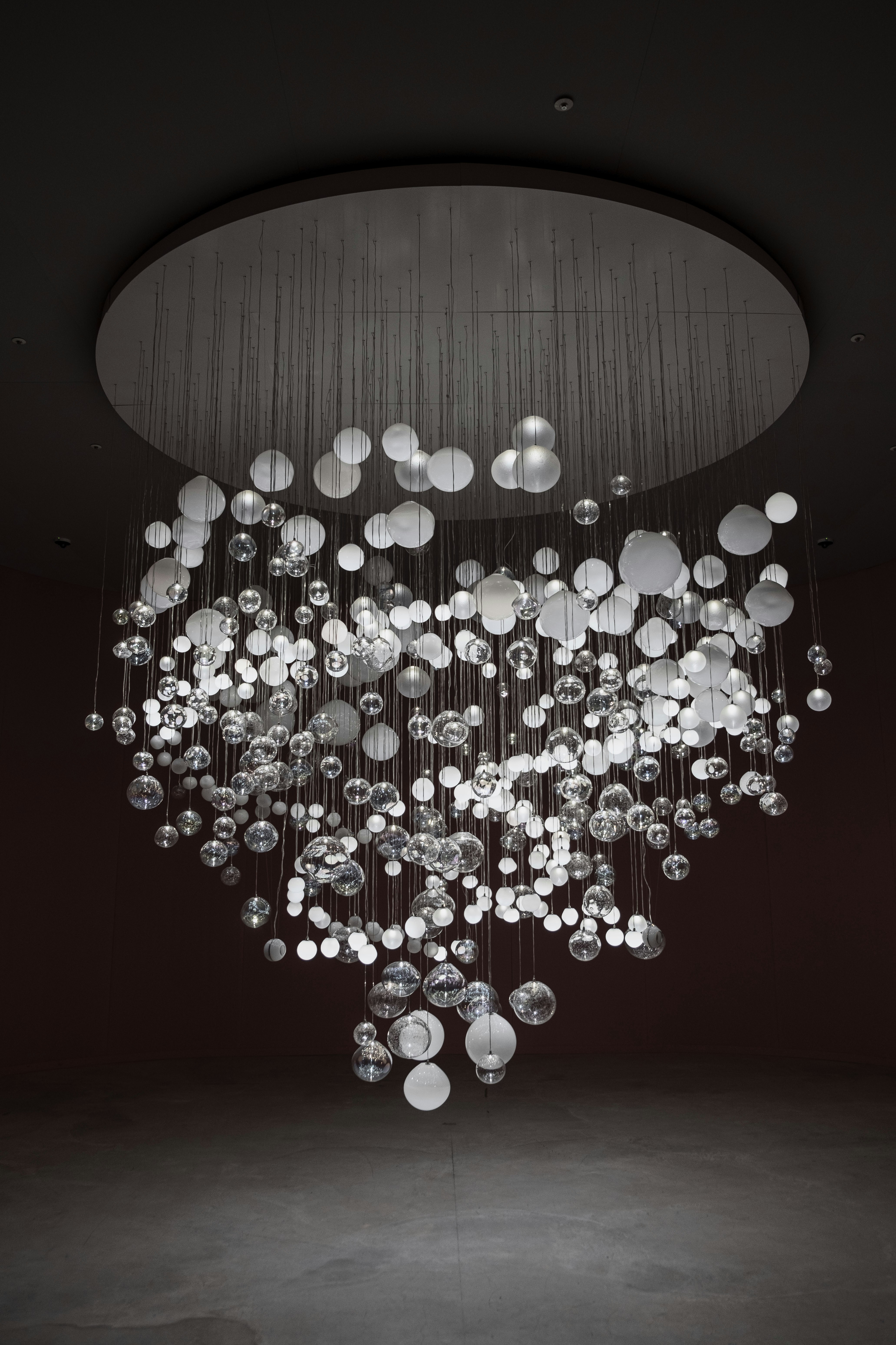 Modern artistic chandelier with suspended spheres installed in UAE