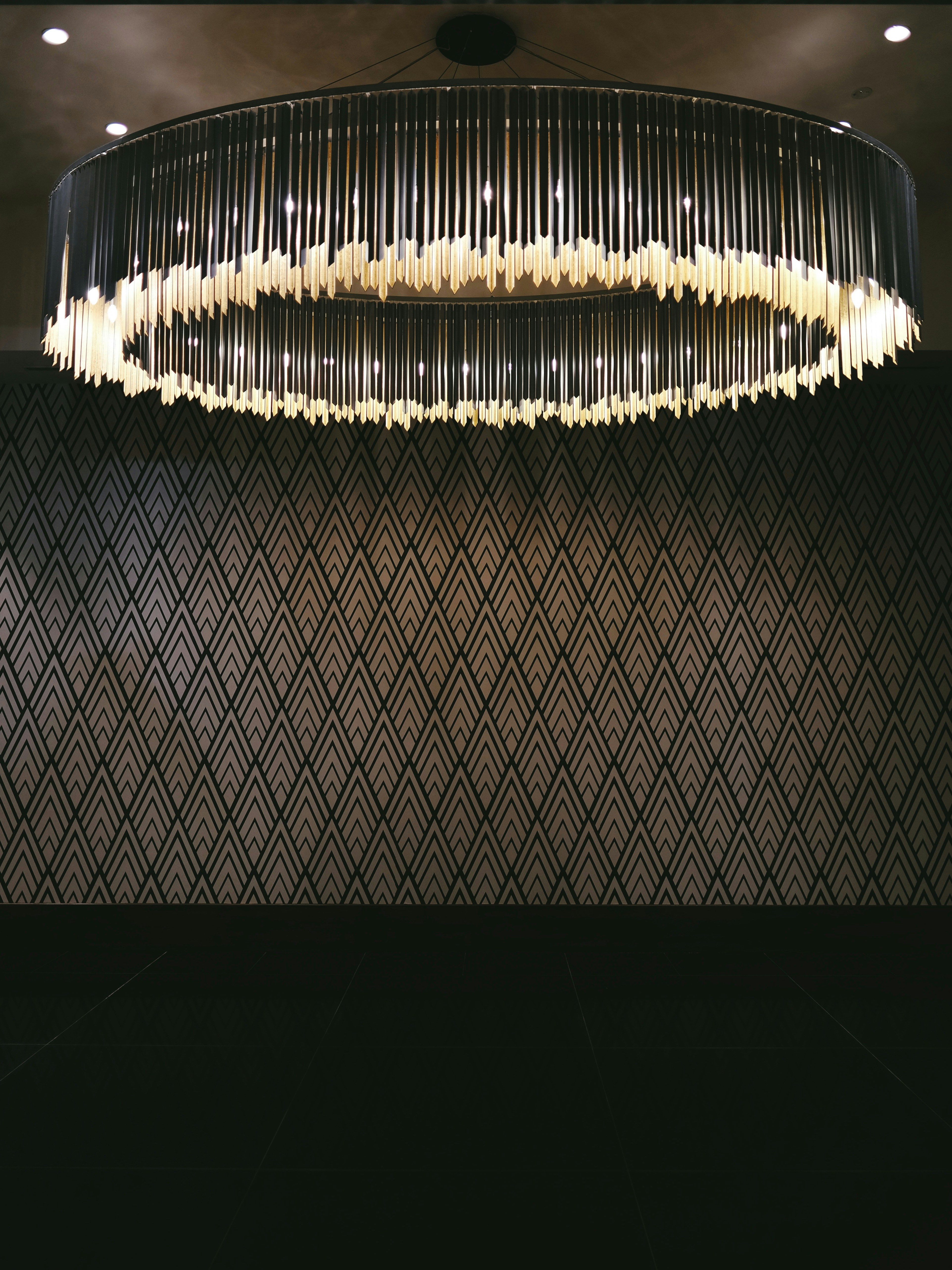 Large circular modern chandelier with vertical elements in UAE residence