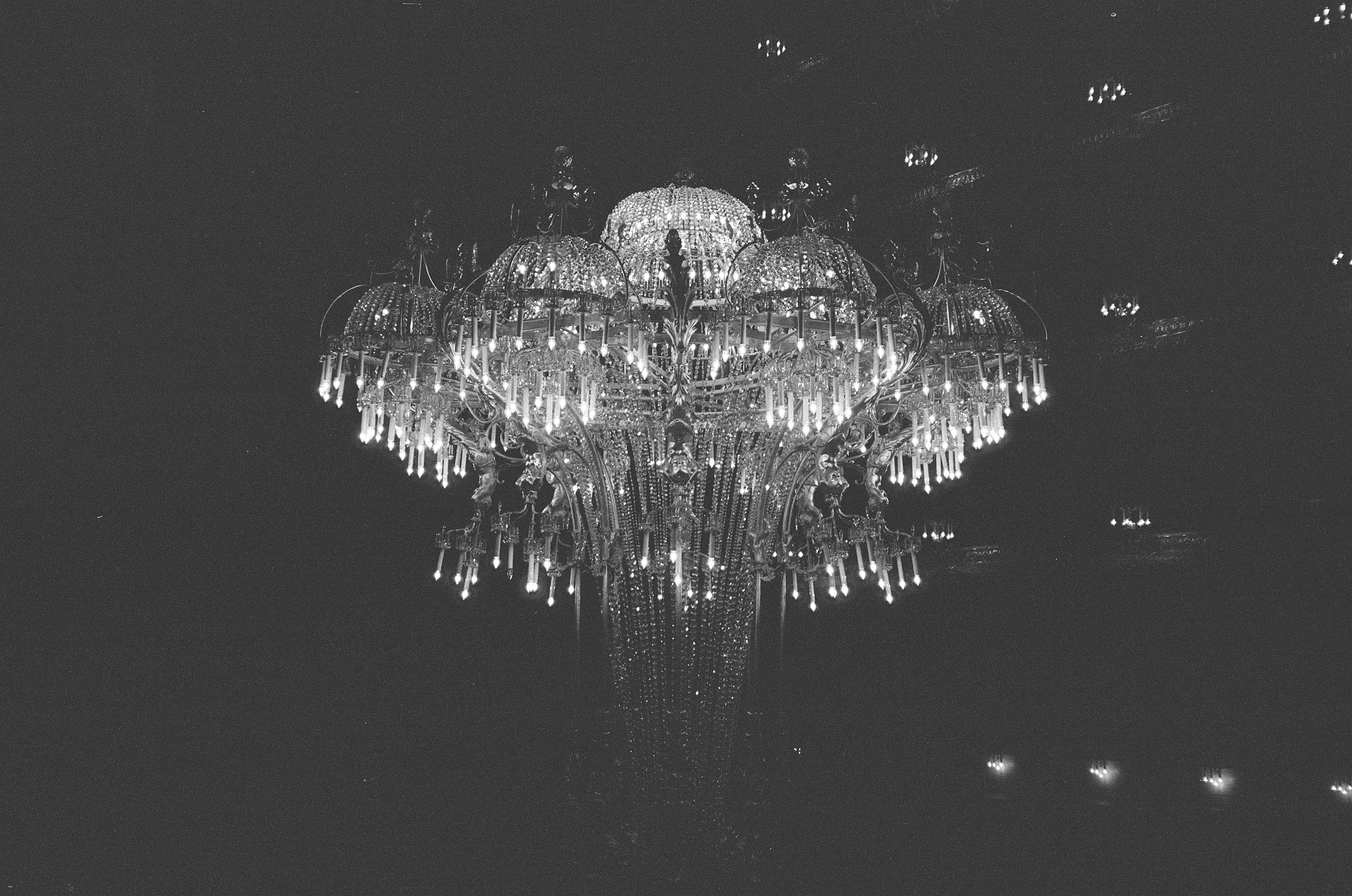 Grand multi-level crystal chandelier installation in high-ceilinged UAE space