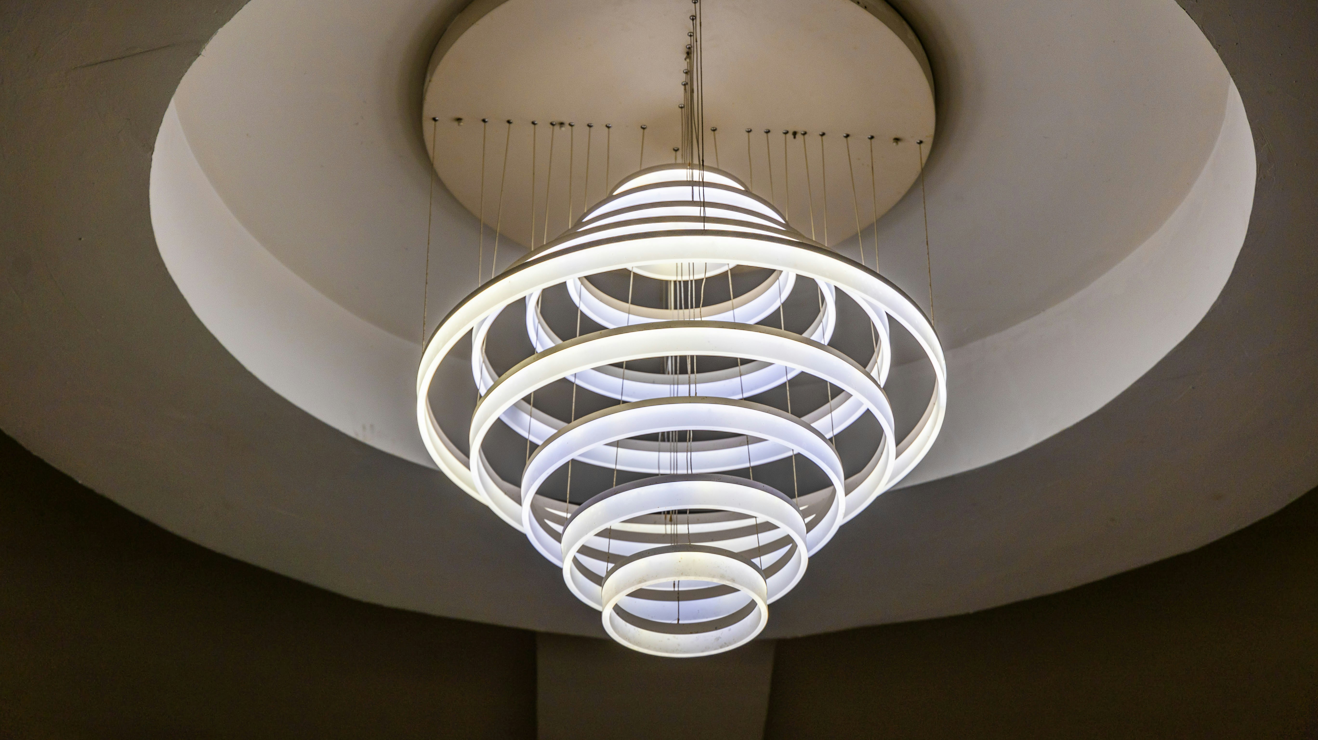 Modern spiraling chandelier with concentric rings installed in Dubai