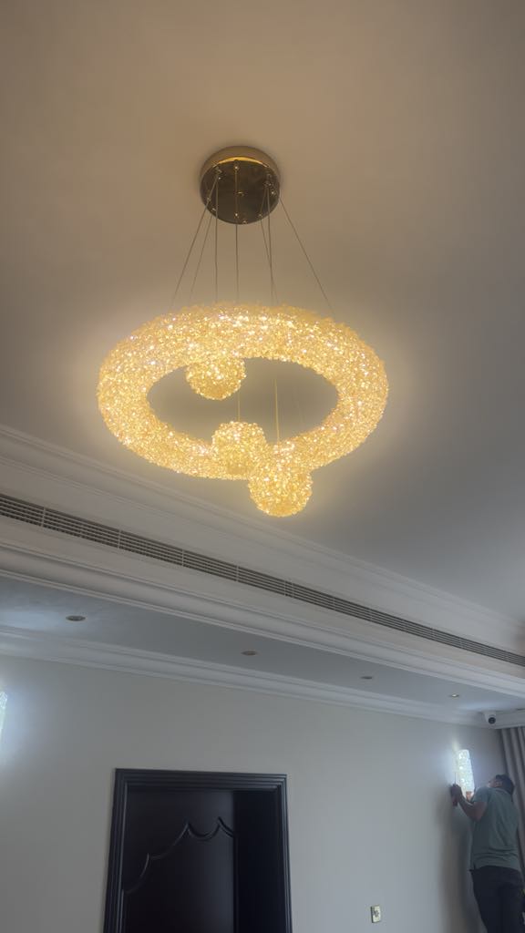 Abstract golden sparkling chandelier installation in luxury space